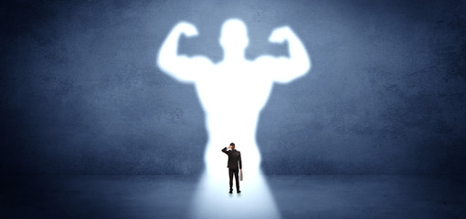 Businessman standing and dreaming about a strong superhero