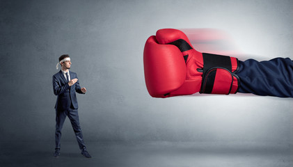 Little man fighting with a giant red boxing glove
