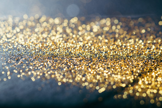 gold confetti on black background