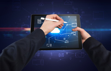 First person view of a hand using tablet with cloud office concept
