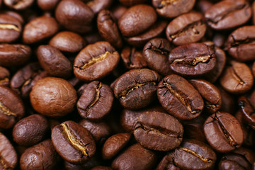 Aroma roasted coffee beans, brown background. Soft focus close up.
