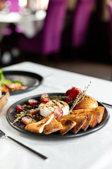 Grilled camembert with baked apple and grapes with slices of bread cakes