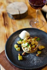 English apple crumble with nuts, mint and ice cream ball