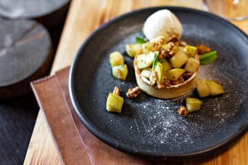 English apple crumble with nuts, mint and ice cream ball
