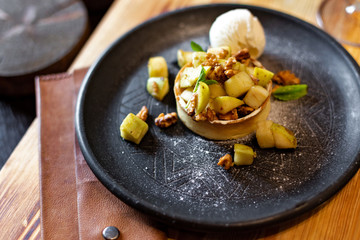 English apple crumble with nuts, mint and ice cream ball