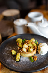 English apple crumble with nuts, mint and ice cream ball