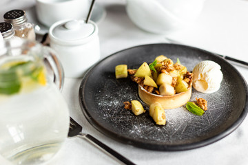 English apple crumble with nuts, mint and ice cream ball