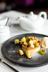 English apple crumble with nuts, mint and ice cream ball