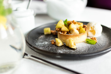English apple crumble with nuts, mint and ice cream ball