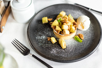 English apple crumble with nuts, mint and ice cream ball