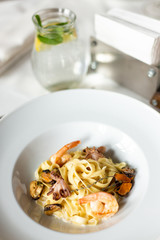 Kraft paste with seafood: mussels, shrimps and octopus in a creamy sauce