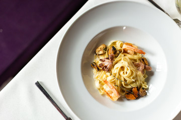Kraft paste with seafood: mussels, shrimps and octopus in a creamy sauce