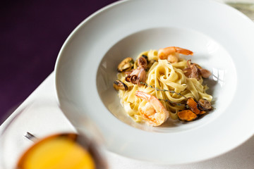 Kraft paste with seafood: mussels, shrimps and octopus in a creamy sauce