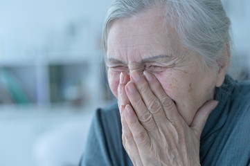 Portrait of happy senior woman posing at home