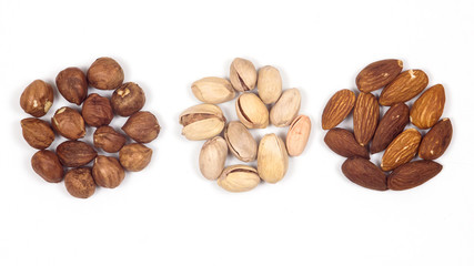 Different nuts on a white background. Almond, hazelnut, pistachio.
