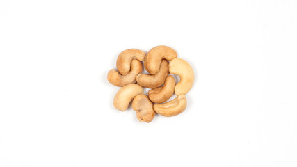 Cashews on a white background. Nuts lined in a circle.