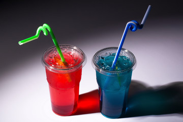 red and blue ice tea on a gray background