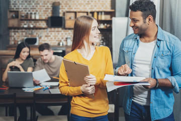 Attractive two colleagues talking about contract