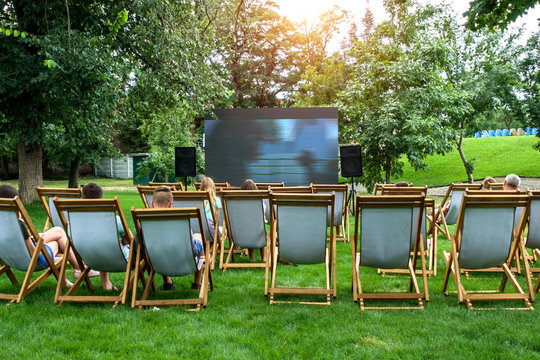 People In A Summer Cinema Are Watching A Movie.