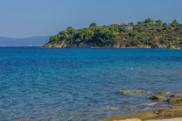 Fototapeta premium Mediterranean sea outdoor scenic landscape photography with vivid blue water surface foreground and opposite island coast line view 