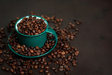 Coffee cup with coffee beans on a stone background