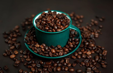 Coffee cup with coffee beans on a stone background