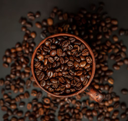 Coffee cup with coffee beans on a stone background