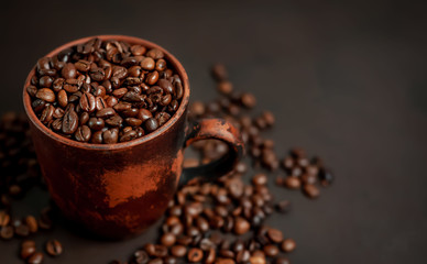 Coffee cup with coffee beans on a stone background
