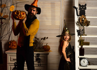Girl and bearded man with proud faces in carnival room