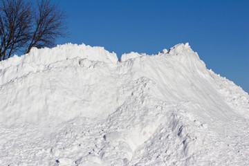 Large pile of snow with blue sky background