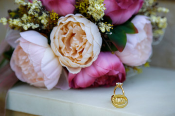  a bouquet of flowers and wedding rings