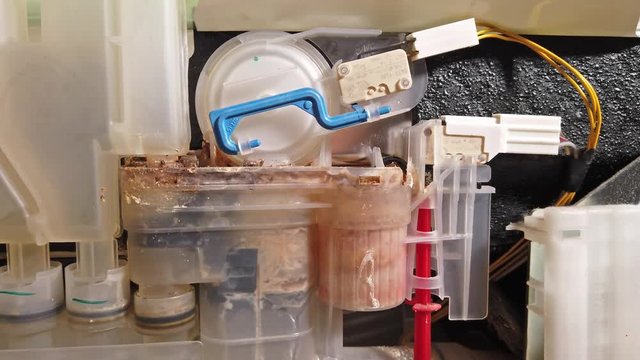 Inside view of an calcified dish washing machine