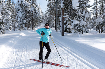 Woman cross country skiing in Lapland Finland