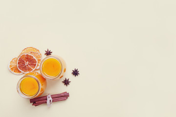 healthy drink, hot spicy fruit or pumpkin tea or cocktail on yellow background, top view, copy space
