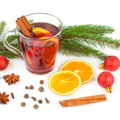 Hot red mulled wine isolated on white background with spices, orange slice, anise and cinnamon...