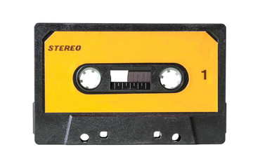 An old vintage cassette tape from the 1980s (obsolete music technology). Black plastic body, canary yellow label with the texts Stereo and 1 (one).