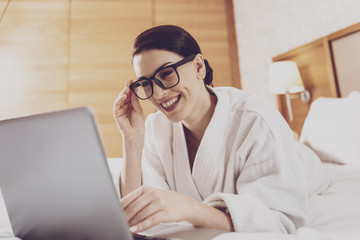 Young businesswoman in glasses using laptop