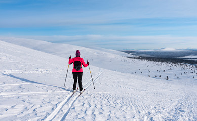 Fototapeta na wymiar Woman cross country skiing