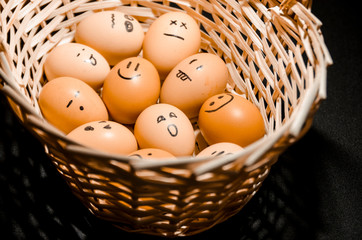 Eggs with smiling faces in the basket