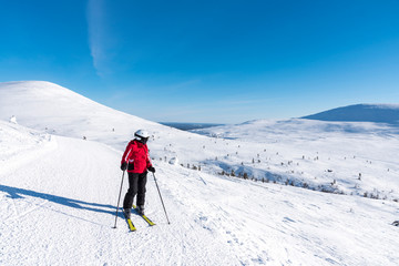 Fototapeta na wymiar Woman downhill skiing in Lapland Finland