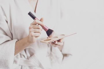 Close up of woman holding cosmetic products