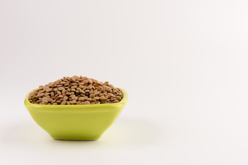 Yellow lentil in a bowl isolated on white background
