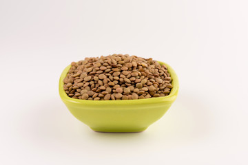 Yellow lentil in a bowl isolated on white background