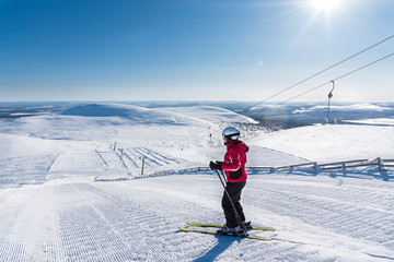 Fototapeta na wymiar Woman downhil skiing in Lapland Finland