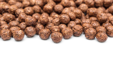Chocolate cereal balls on white. Space for text.