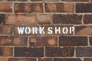 Workshop sign brick wall