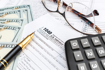 Naklejka na ściany i meble Pen, money, calculator and glasses on tax form.