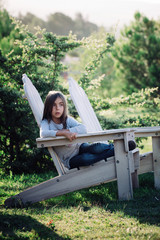 Teenager sitting on a mountain top
