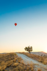 Colorful hot air balloon flying over at fairy chimneys in Nevsehir, Goreme, Cappadocia Turkey. Hot air balloon flight at spectacular Cappadocia Turkey.  