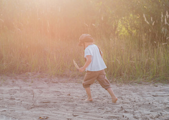 Happy kid playing on sunset